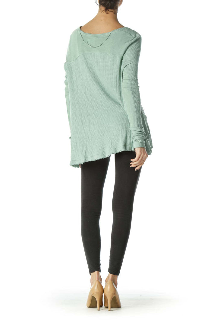 Back view of mint green Free People waffle knit oversized top showing flowy silhouette