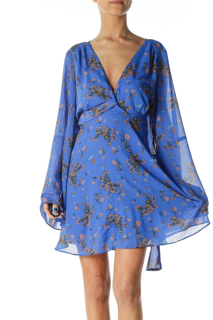 Front view of Free People blue floral long sleeve mini dress with V-neckline