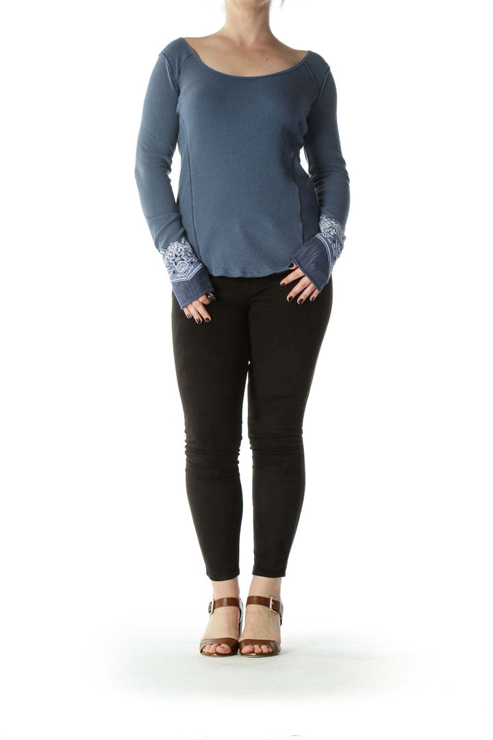 Front view of Free People blue waffle knit top with lace cuffs