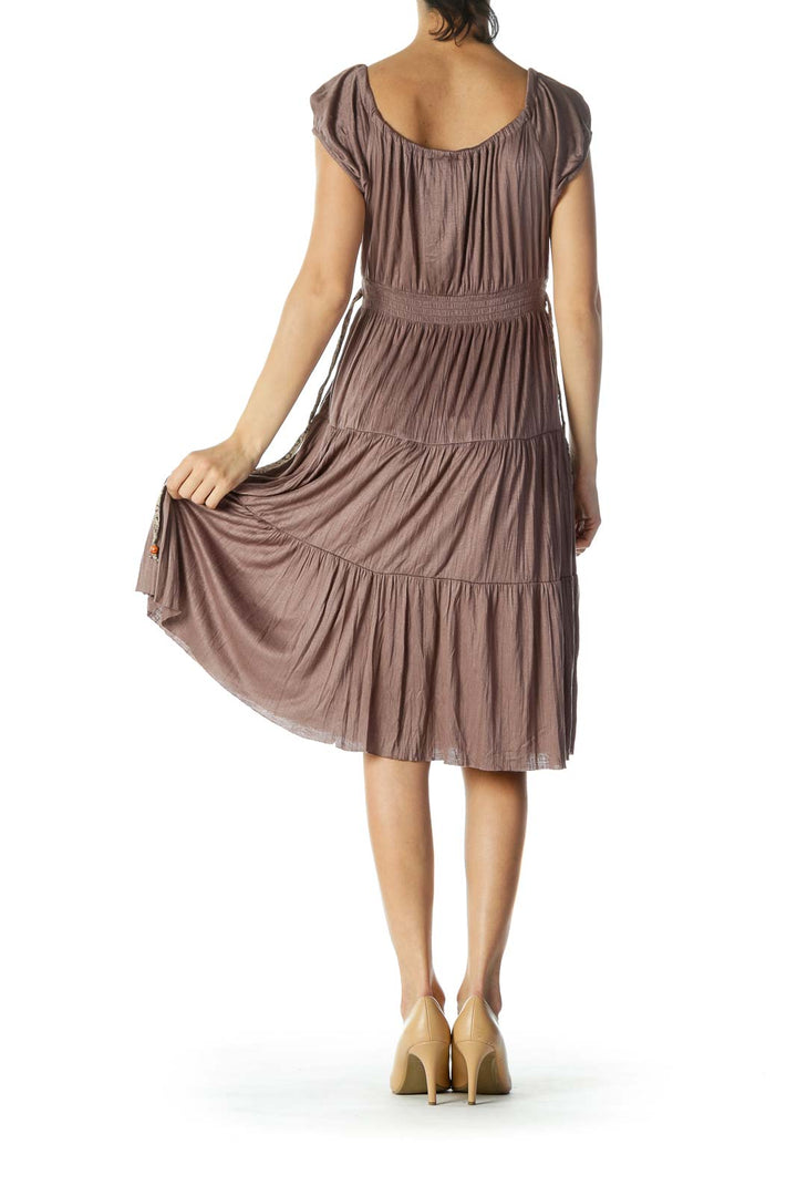 Back view of Free People taupe tiered midi dress showing flowing tiers