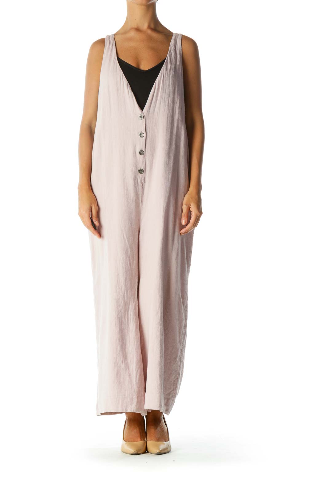 Front view of Free People blush pink sleeveless jumpsuit with button-front closure