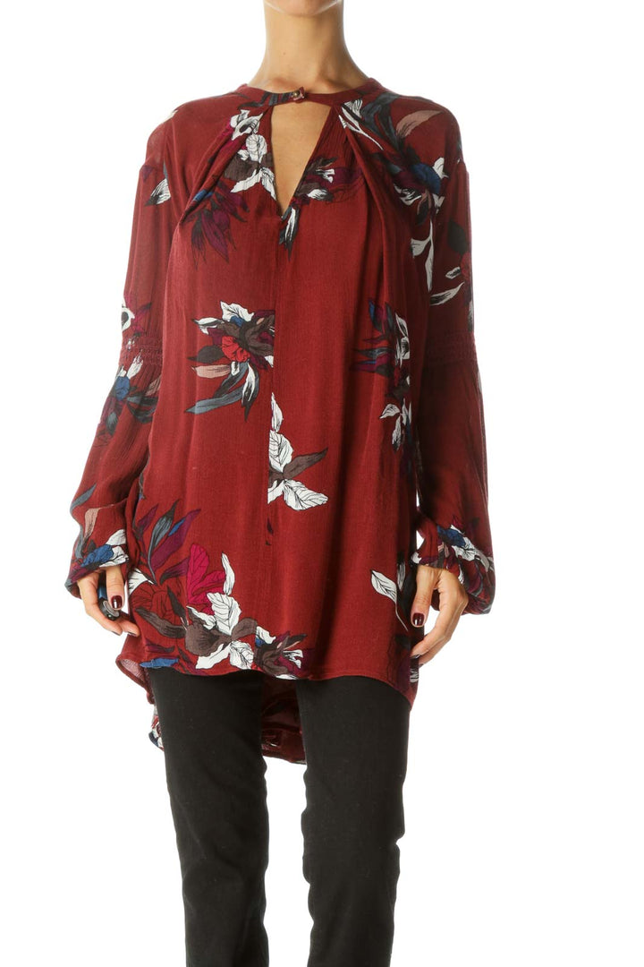 Front view of burgundy Free People tunic top with floral print and keyhole neckline