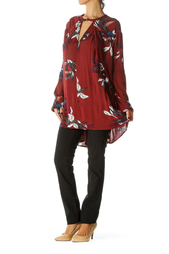 Front view of burgundy Free People tunic top with floral print and keyhole neckline