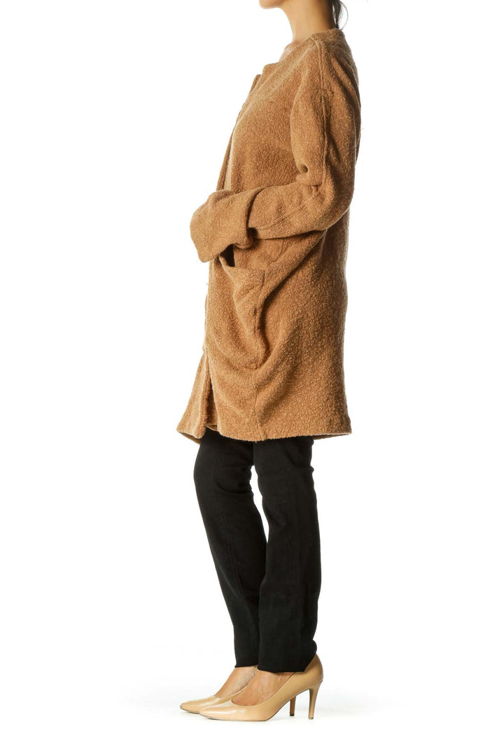 Front view of camel oversized knit cardigan from Free People