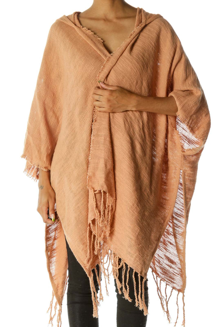 Front view of peach Free People fringed hooded poncho on model