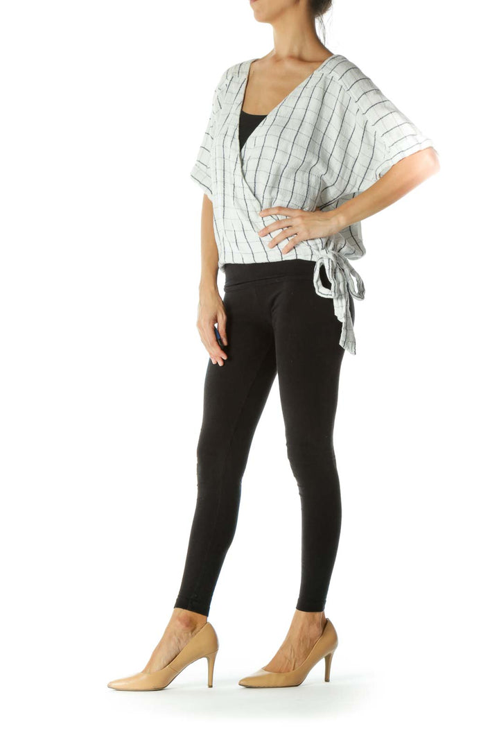 Front view of Free People white striped wrap top with V-neck and tie waist