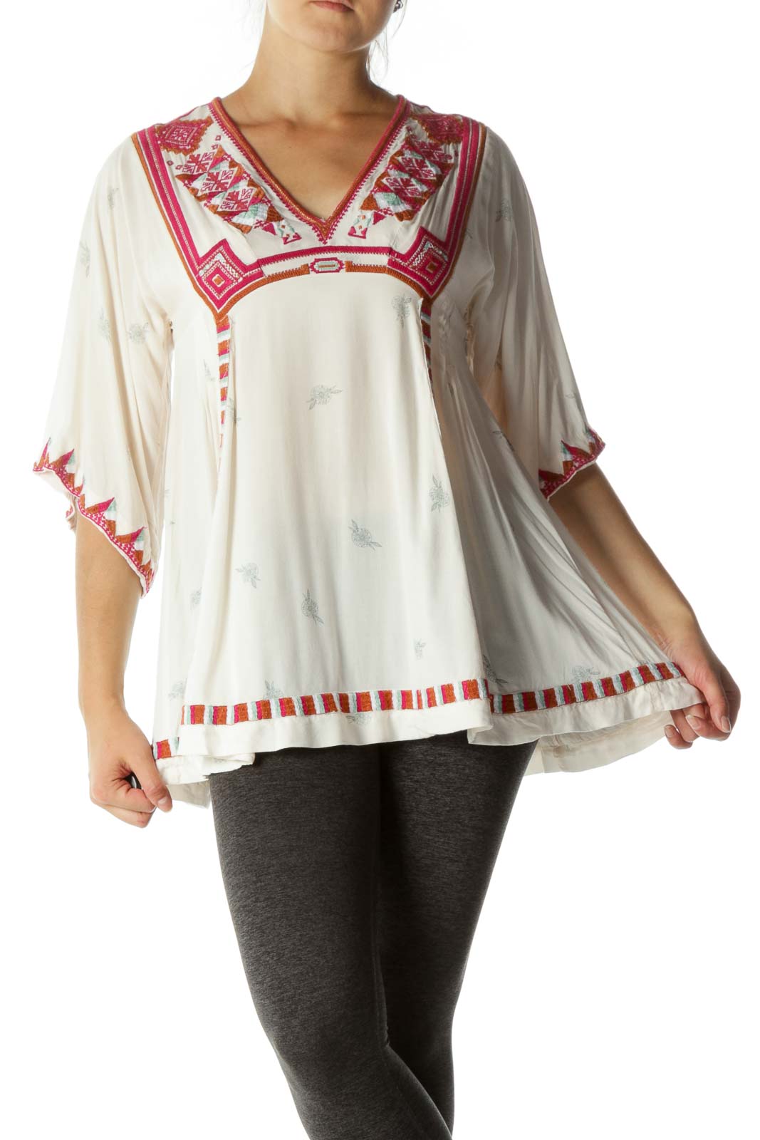 Front view of white Free People tunic top with red embroidery and V-neckline