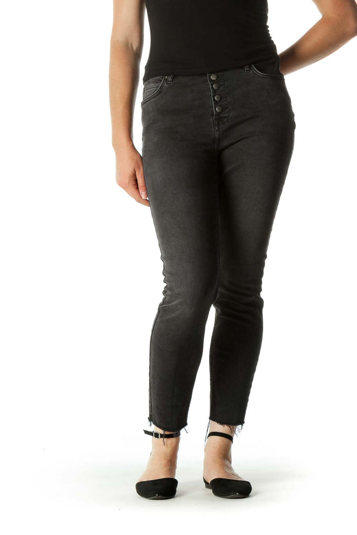 Front view of Free People black distressed skinny jeans with button-fly closure