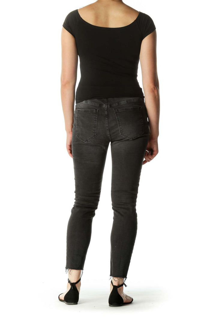 Back view of Free People black distressed skinny jeans showing pocket design and fit