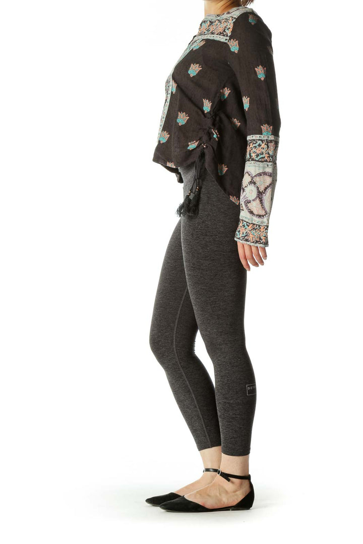 Front view of Free People gray floral top with embroidered V-neck and bell sleeves