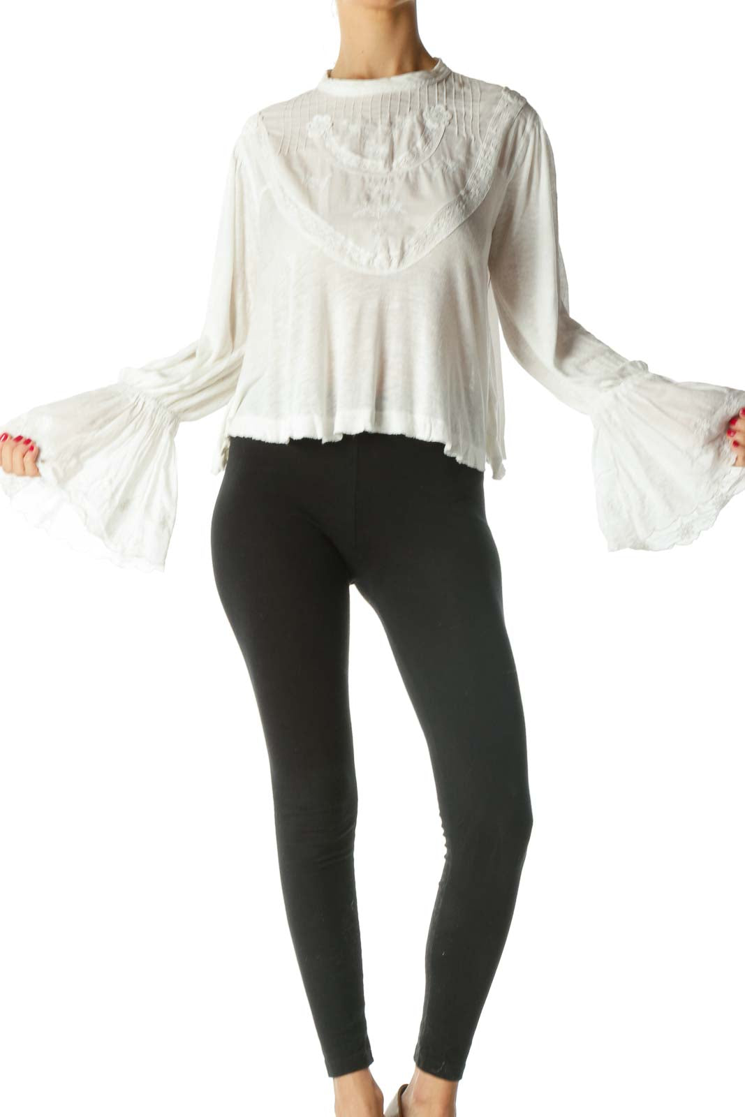 Front view of white Free People crop top with embroidered yoke and bell sleeves