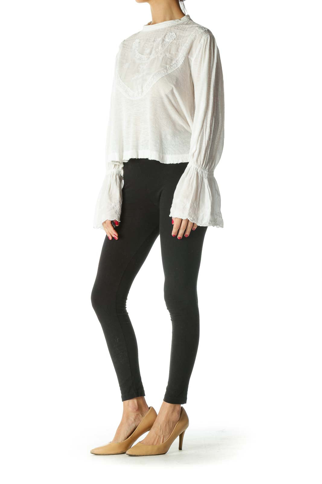 Front view of white Free People crop top with embroidered yoke and bell sleeves