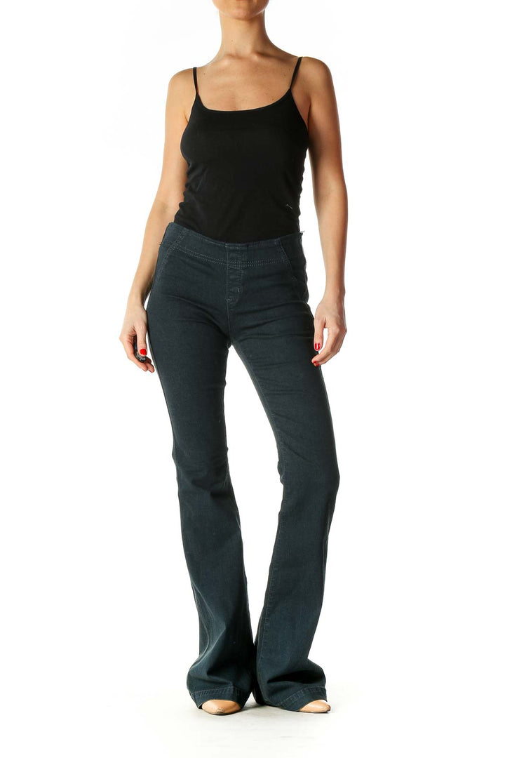 Front view of Free People dark green corduroy flared pants on model