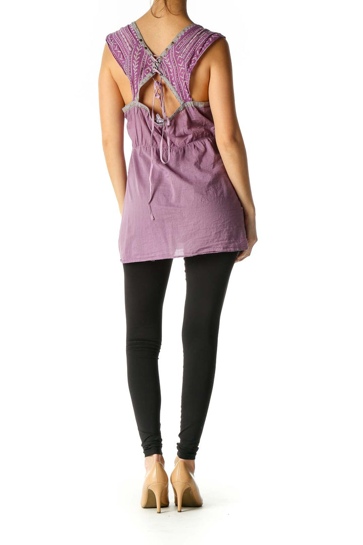 Back view of purple Free People top showing cut-out design with adjustable ties