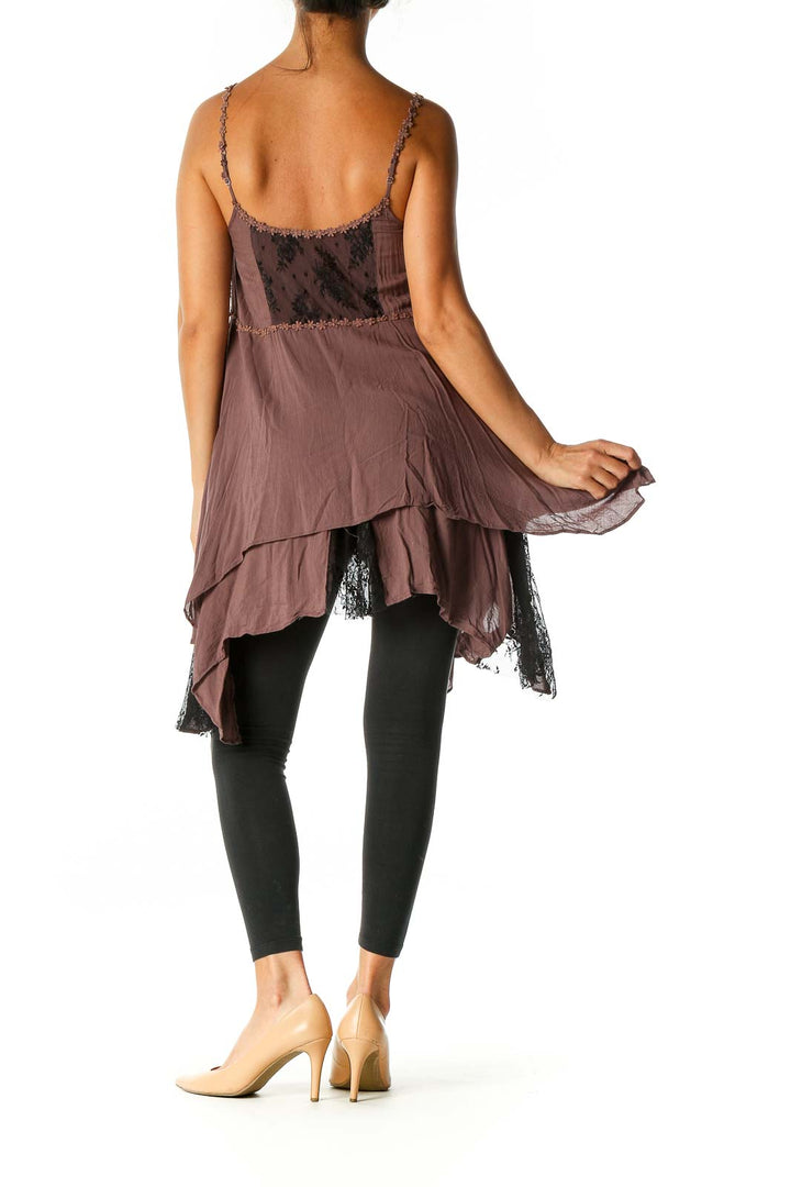 Back view of brown Free People camisole top showing asymmetrical hem and lace details