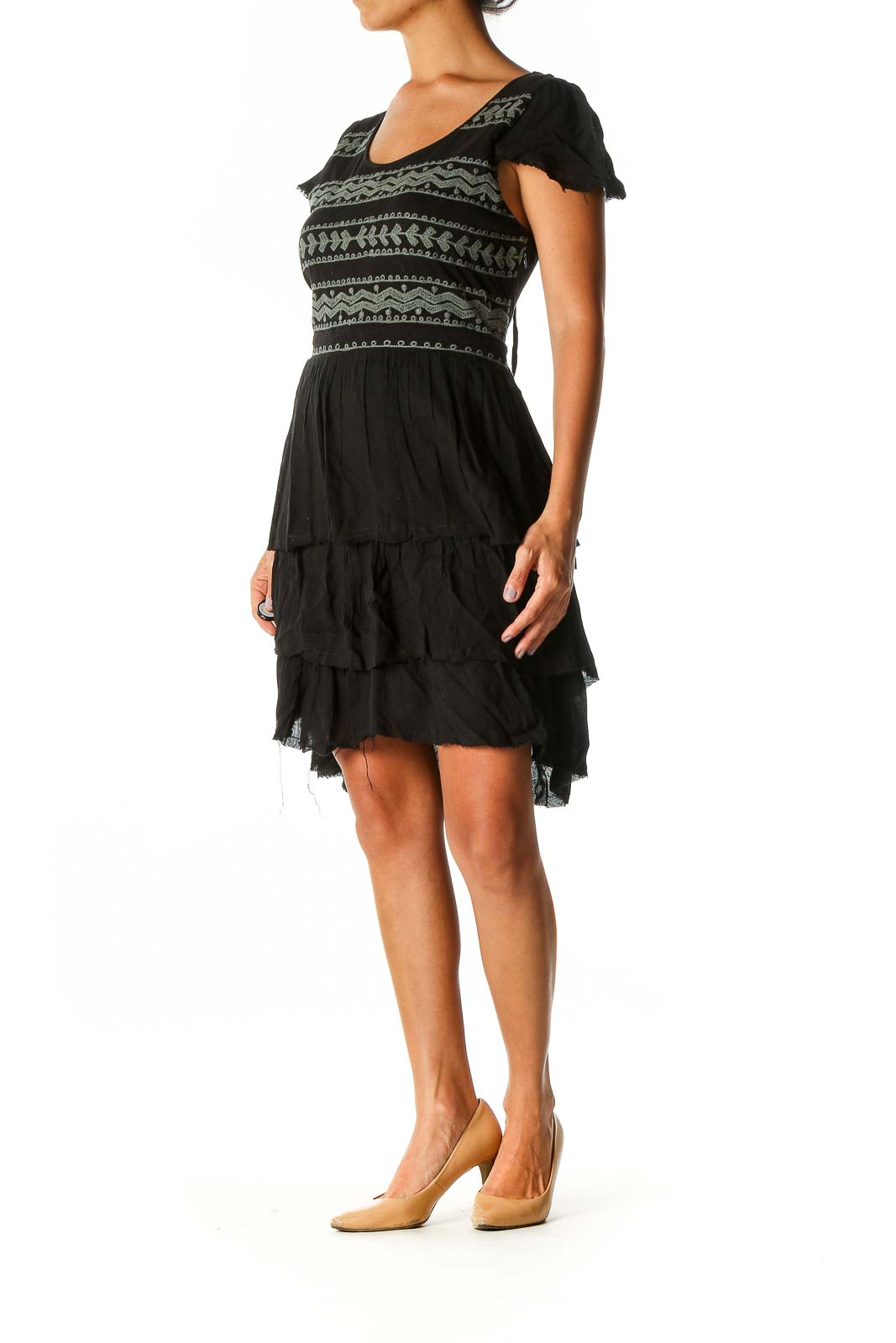 Front view of black Free People mini dress with geometric pattern and tiered skirt