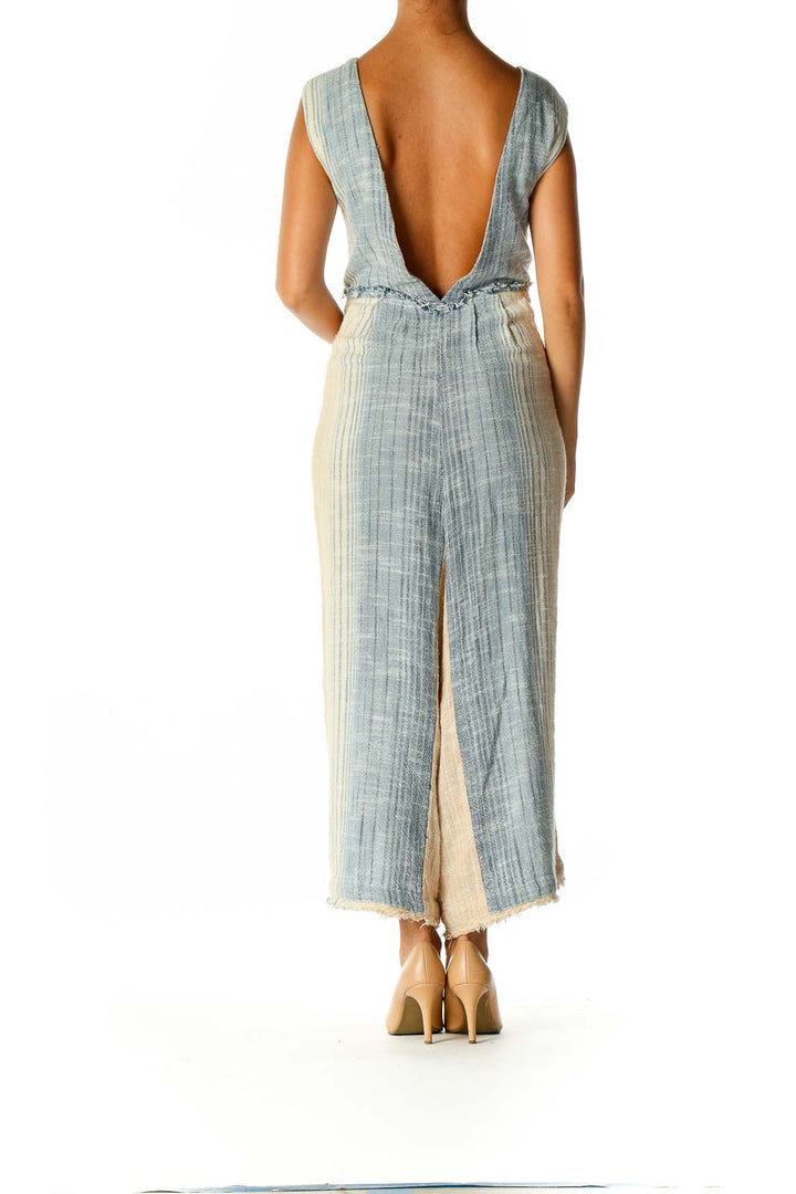 Back view showing open back of Free People blue and cream striped jumpsuit