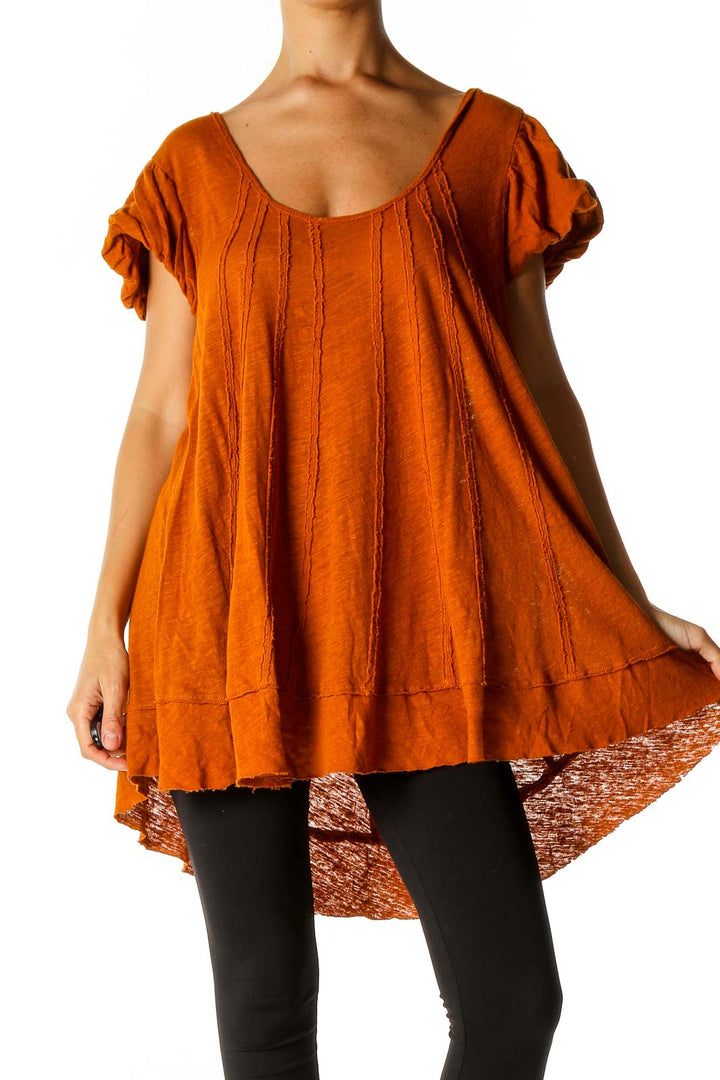 Front view of orange Free People tunic top with scoop neck and flowy silhouette