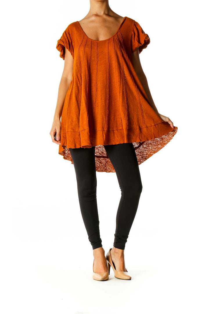 Front view of orange Free People tunic top with scoop neck and flowy silhouette