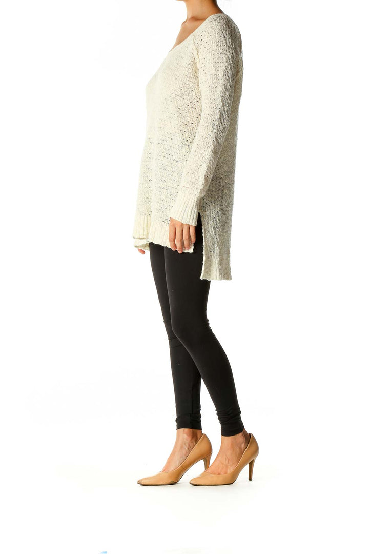 Front view of Free People cream oversized knit sweater on model