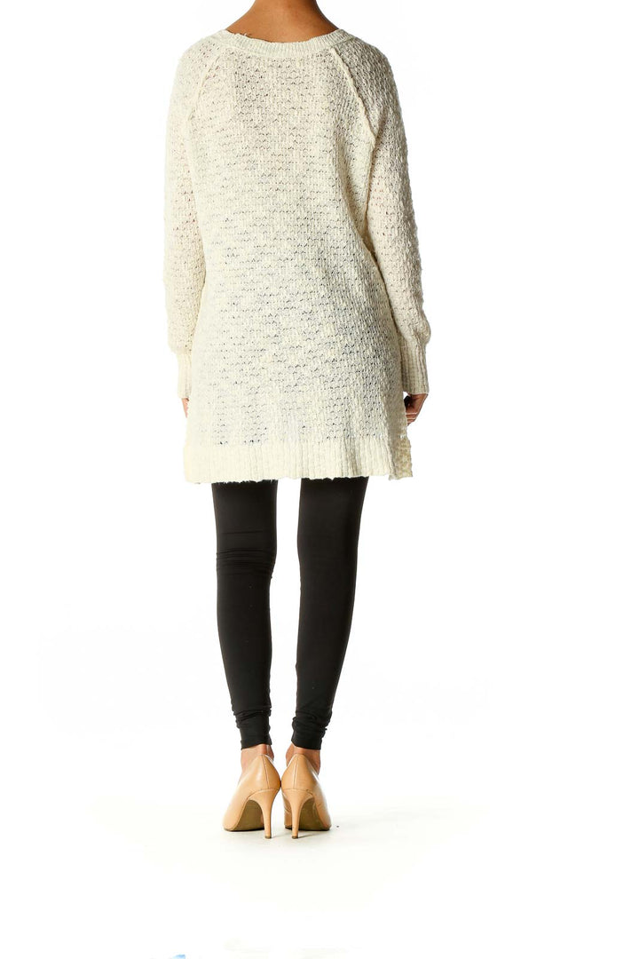 Back view of Free People cream oversized knit sweater showing length and fit