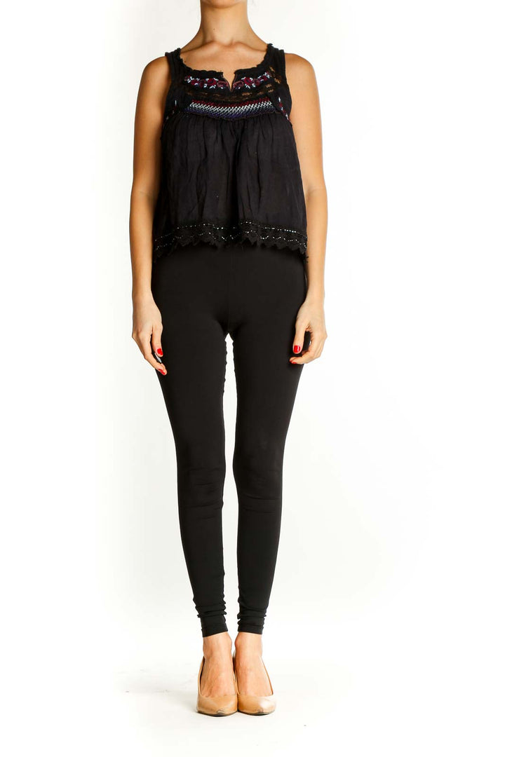 Front view of Free People black embroidered tank top with lace details