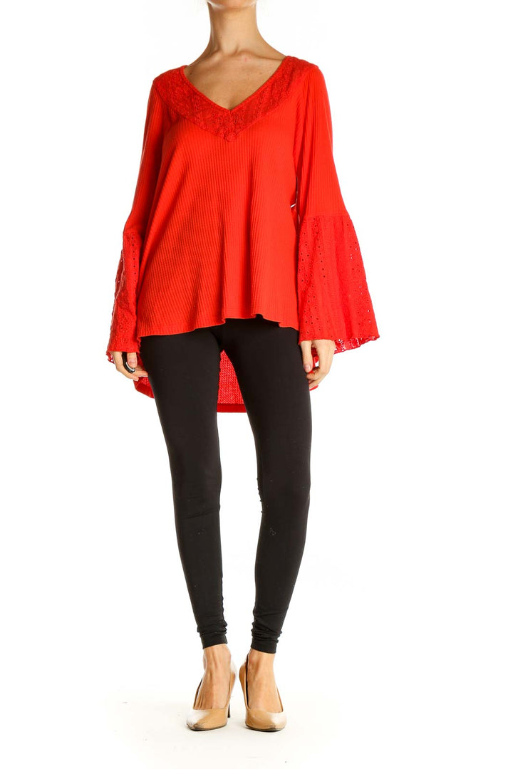 Front view of red Free People tunic top with lace-trimmed bell sleeves and V-neckline