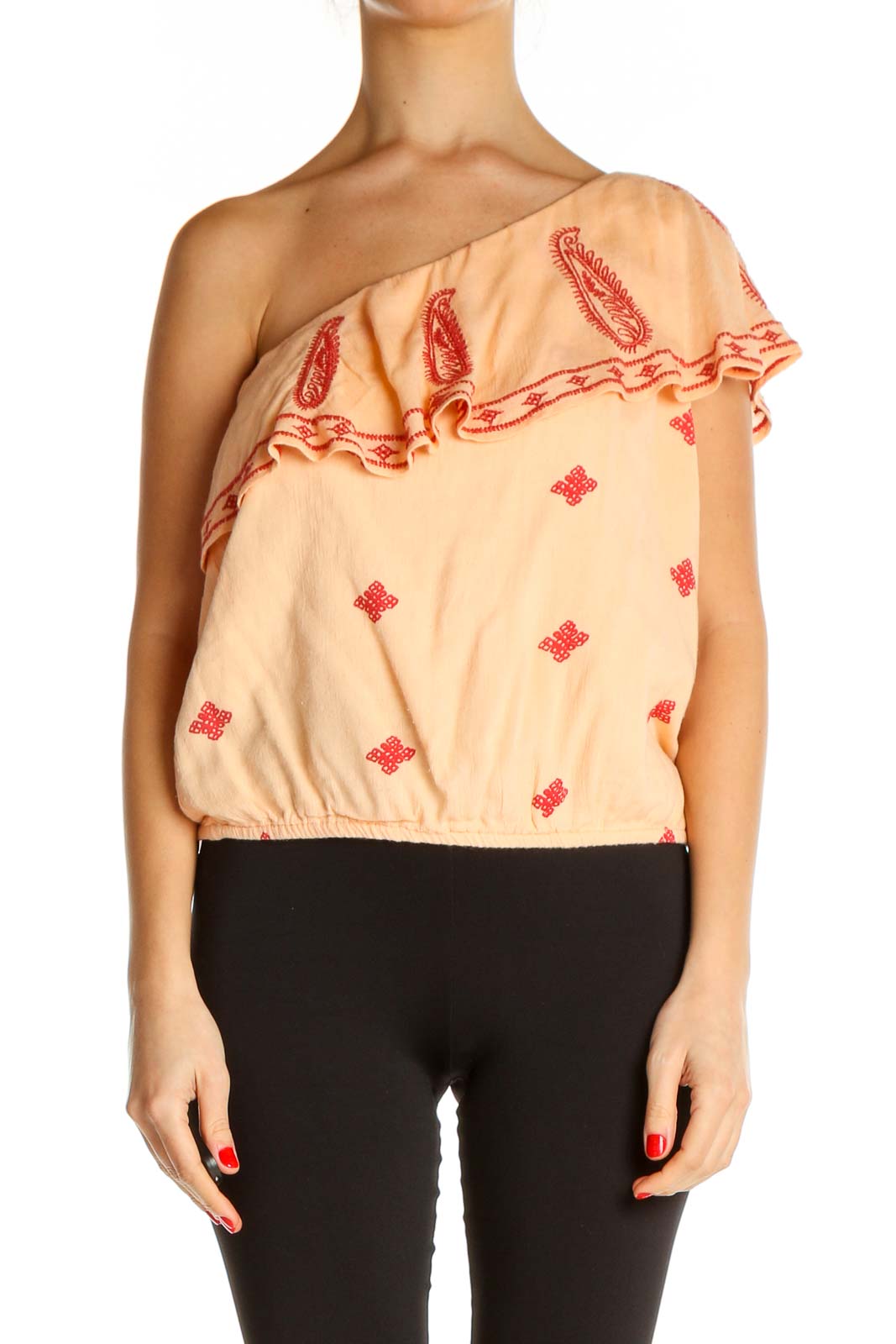 Front view of Free People peach one-shoulder top with red paisley embroidery and ruffled neckline