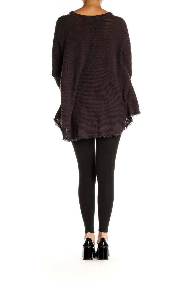 Back view of brown oversized knit sweater showing high-low hemline