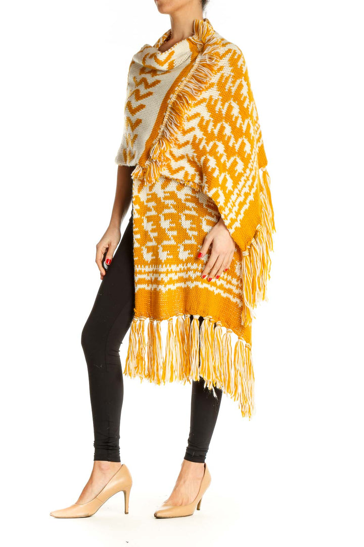 Front view of Free People yellow and white patterned knit cardigan with fringe details