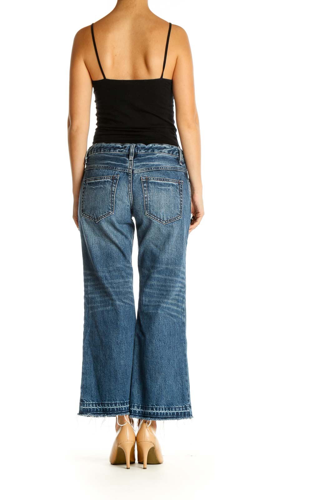 Back view of Free People blue wide-leg cropped denim jeans on model