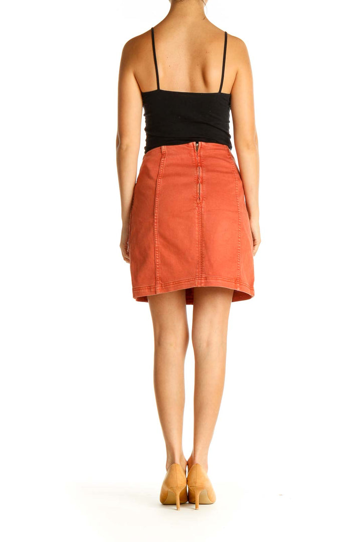 Back view of orange Free People A-line mini skirt with zipper closure