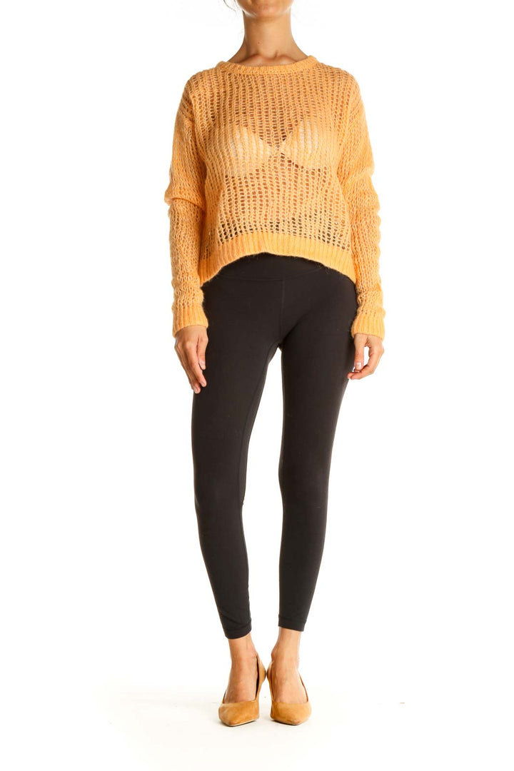 Front view of orange oversized open knit sweater from Free People