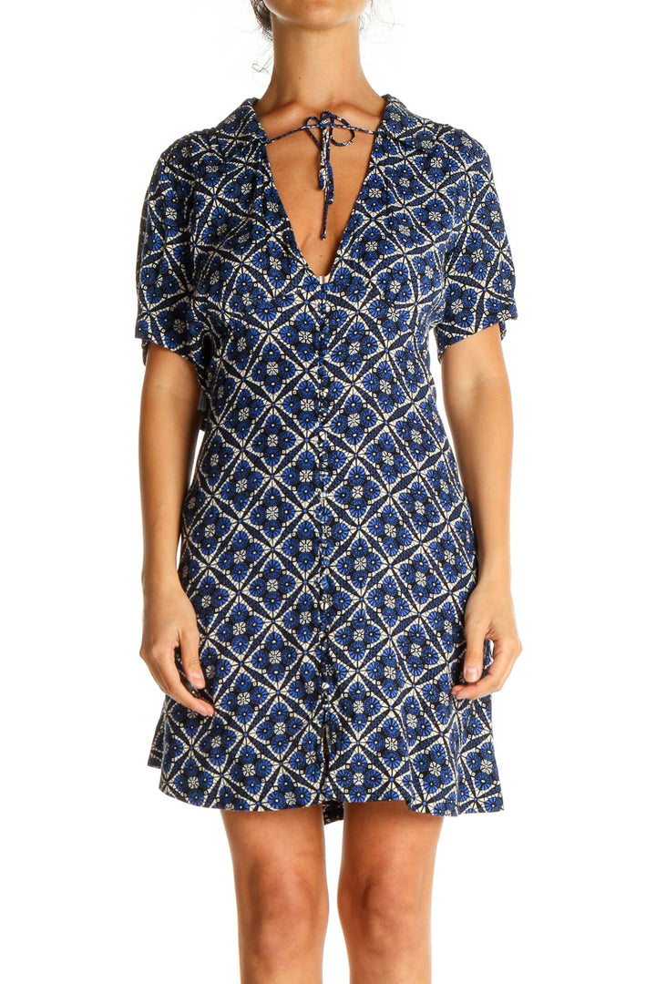 Front view of Free People blue geometric print short sleeve dress with V-neck and tie detail