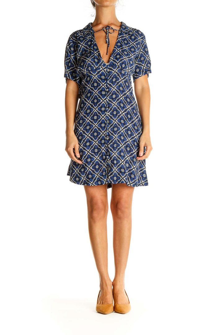 Front view of Free People blue geometric print short sleeve dress with V-neck and tie detail