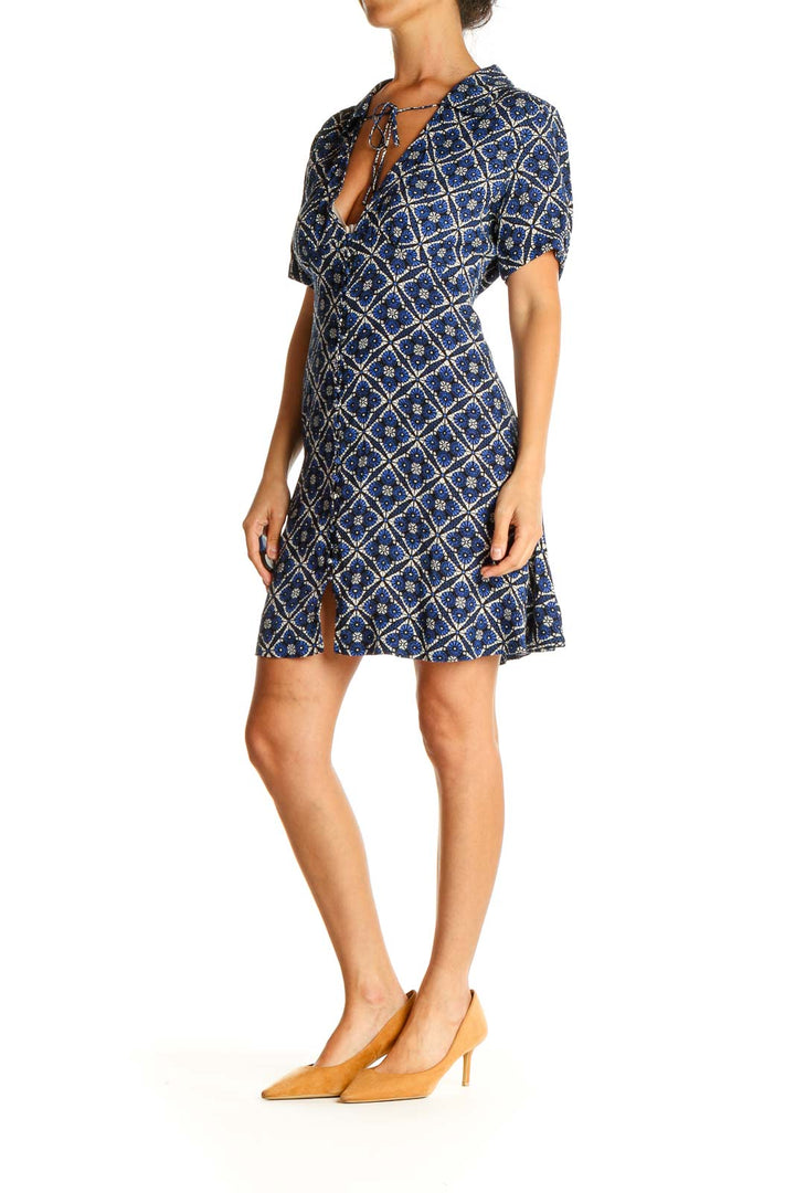 Front view of Free People blue geometric print short sleeve dress with V-neck and tie detail