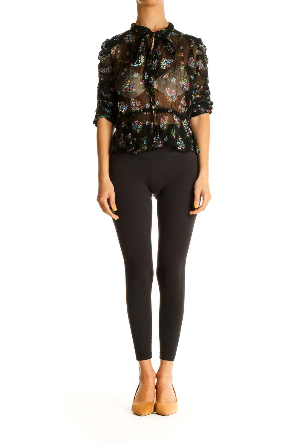 Front view of Free People black sheer floral peplum blouse with tie-neck