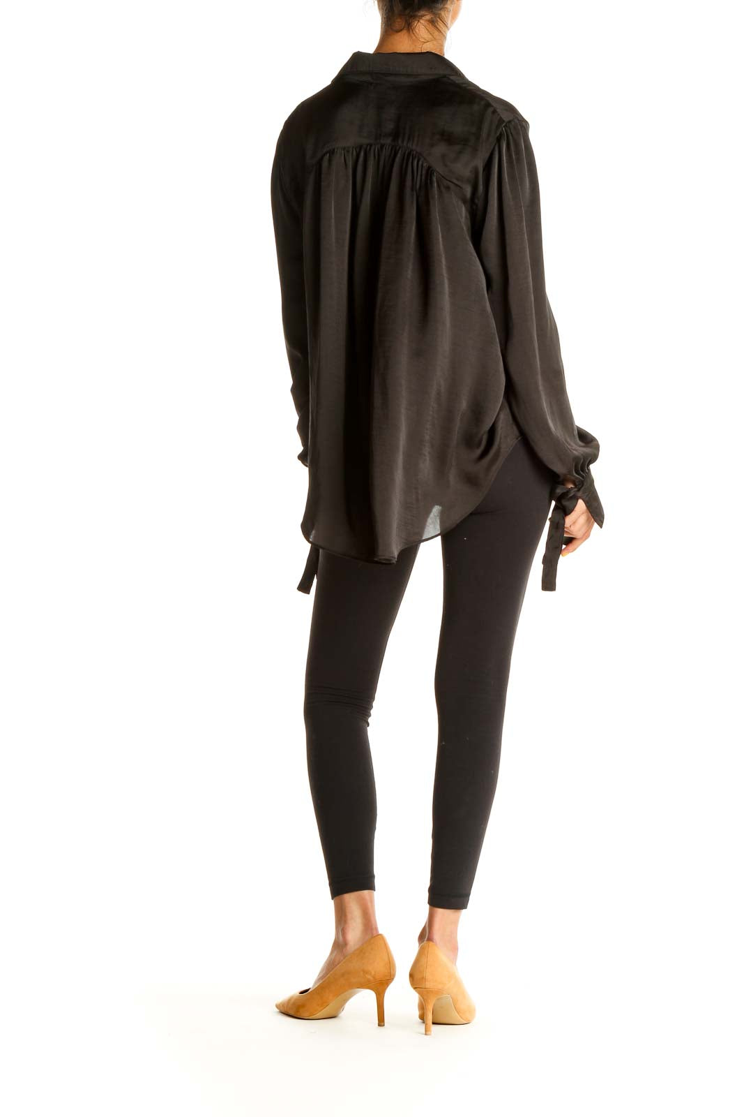 Back view of black Free People flowy button-down blouse showing longer hem