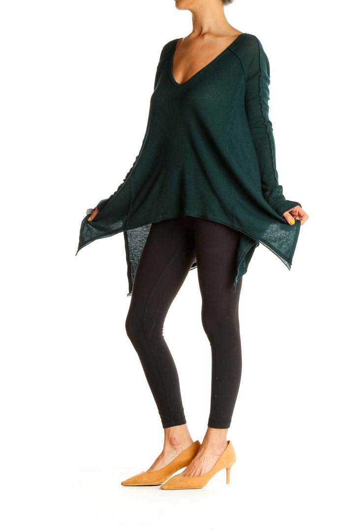 Front view of forest green Free People oversized V-neck sweater with asymmetrical hem