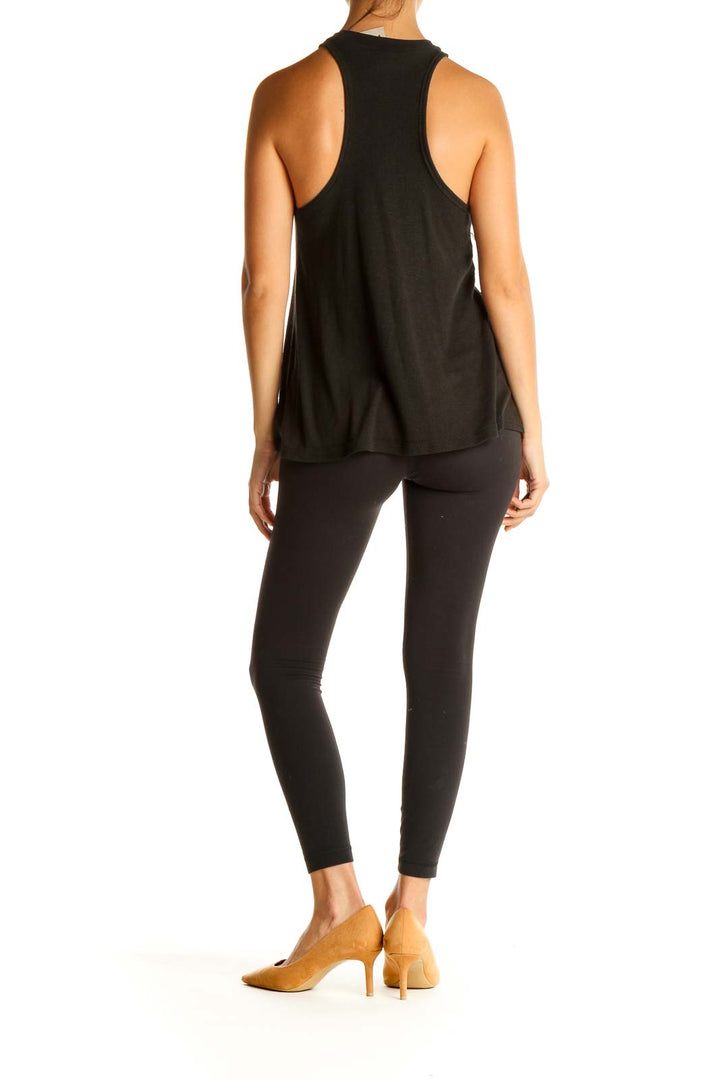 Back view of black Free People racerback tank top with model wearing leggings