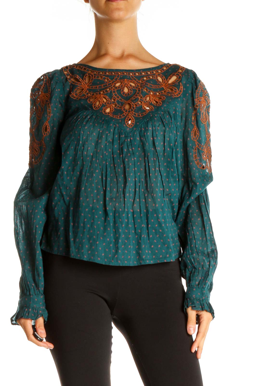 Front view of teal polka dot peasant top with rust embroidery