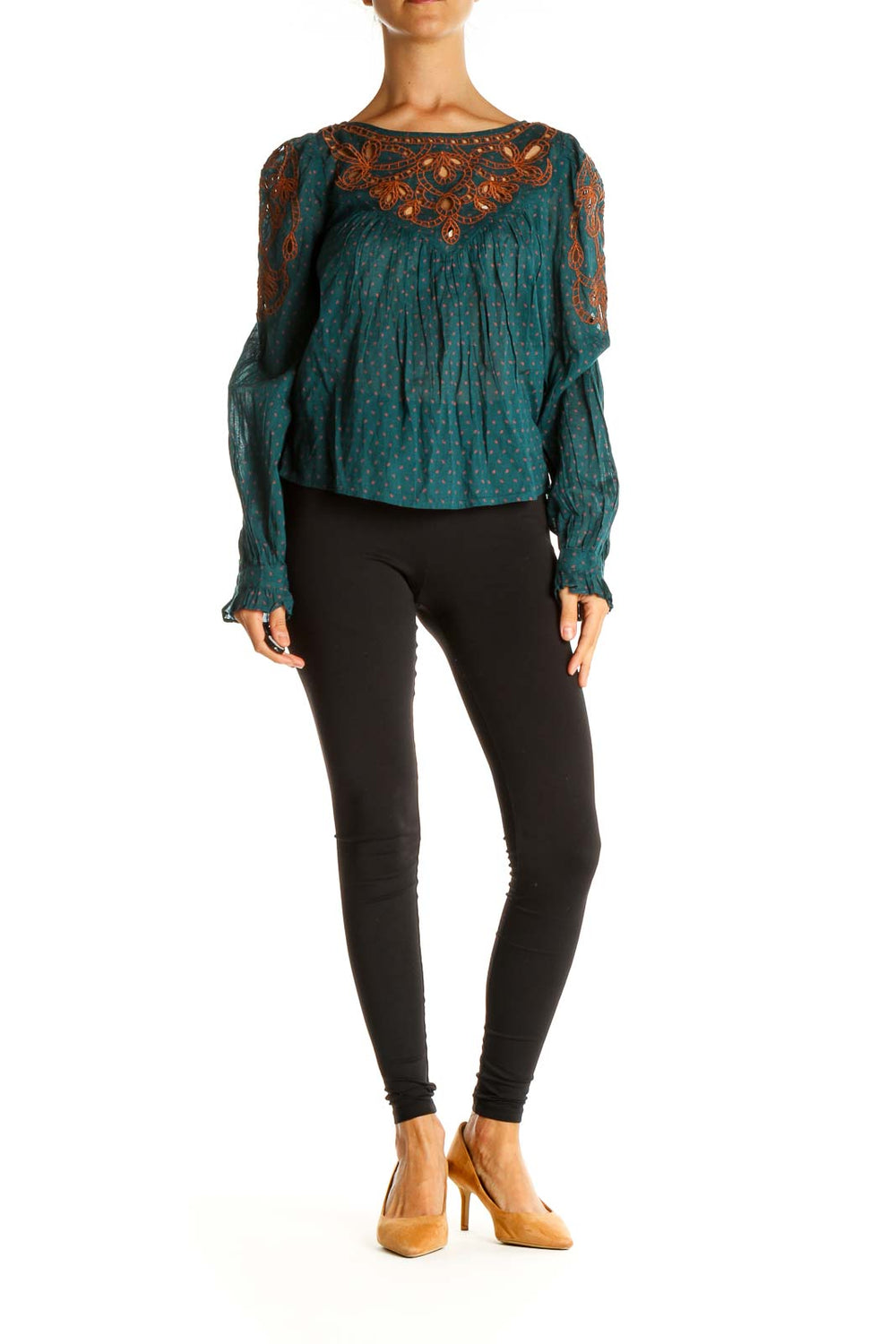 Front view of teal polka dot peasant top with rust embroidery