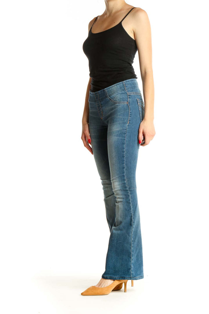 Front view of Free People blue flared denim jeans on model