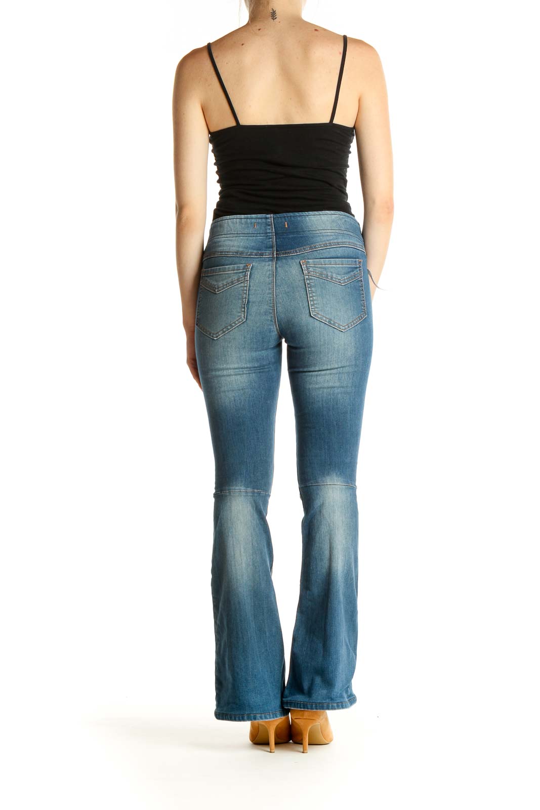 Back view of Free People blue flared denim jeans on model