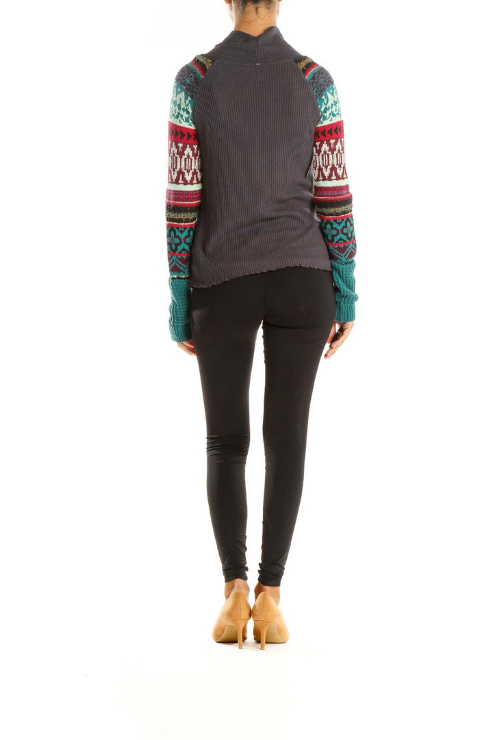 Back view of gray Free People turtleneck sweater showing patterned sleeves and ribbed body