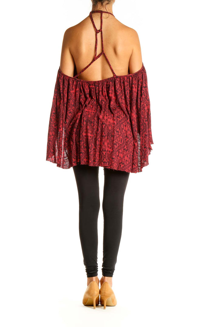 Back view of red floral cold shoulder halter top showing halter neck design