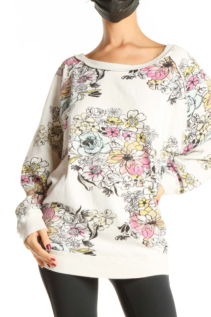 Front view of Free People white oversized sweatshirt with colorful floral print