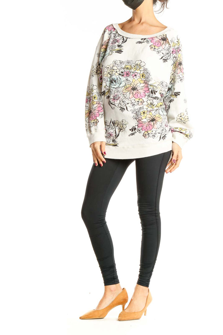 Front view of Free People white oversized sweatshirt with colorful floral print