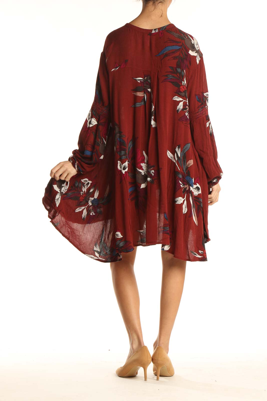 Back view of burgundy floral Free People dress showing flowy silhouette and high-low hemline