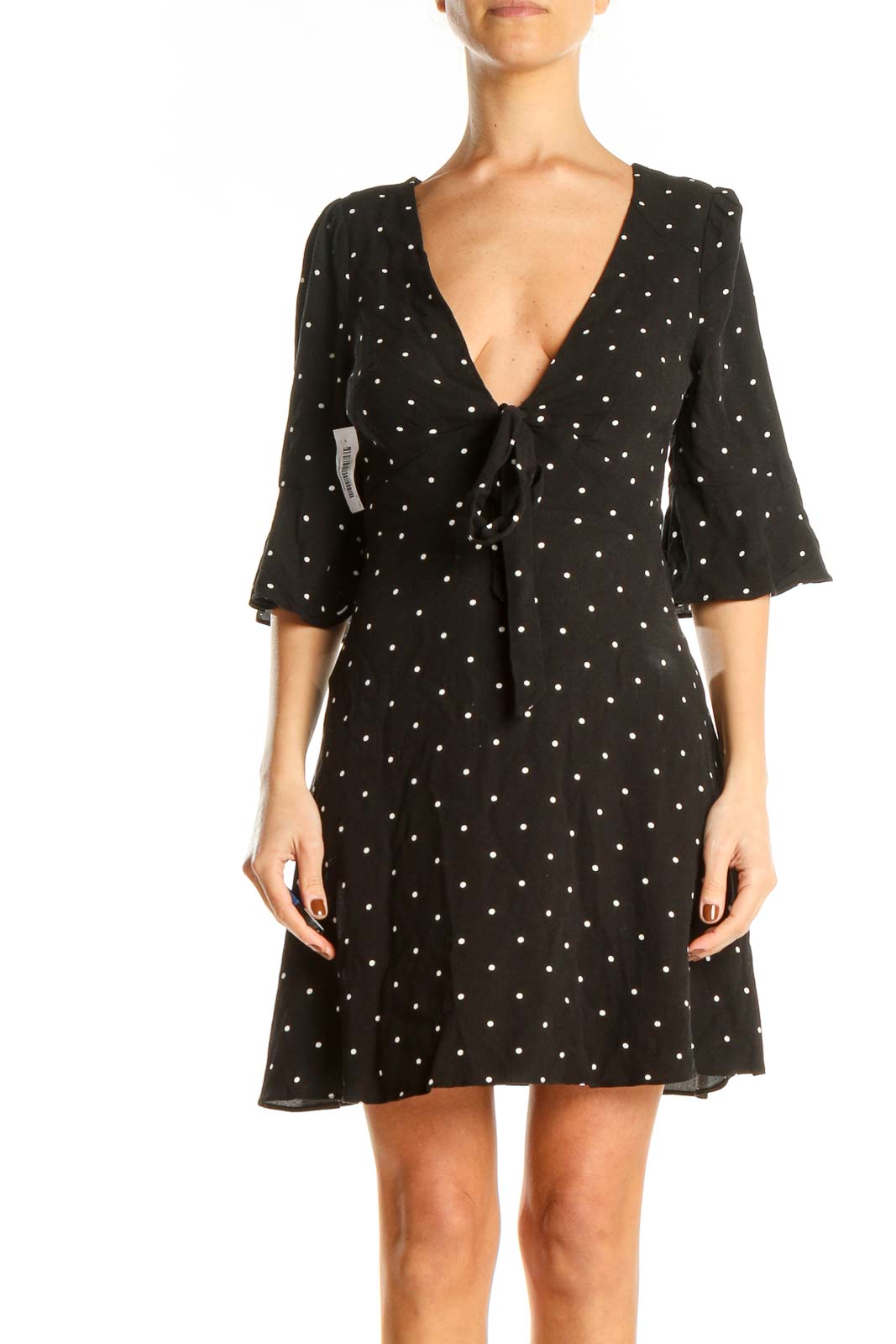 Front view of Free People black polka dot mini dress with V-neck and tie detail